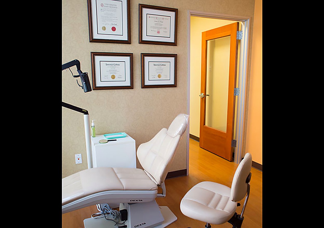 The private consultation room with treatment chair and diplomas