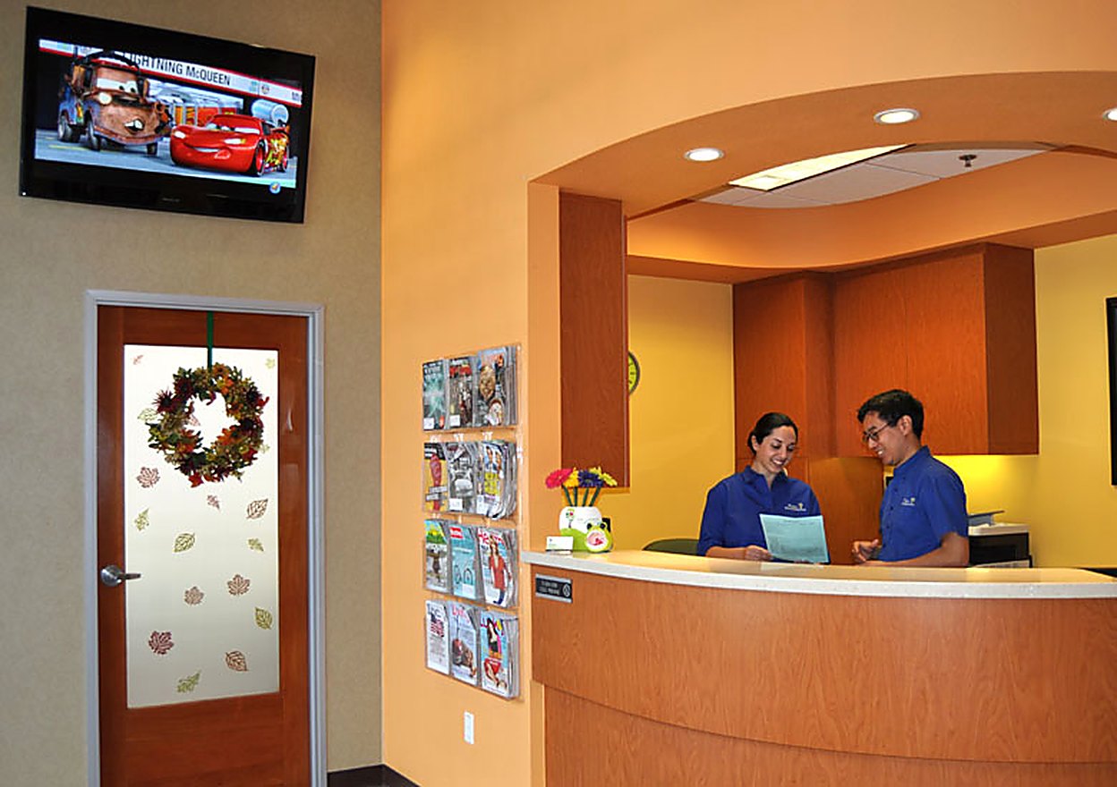 Two team members at the front desk of the practice